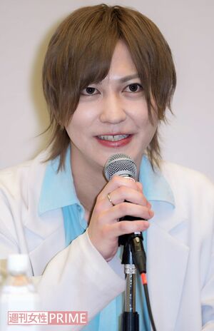 会見で勝訴を報告した新澤典将さん