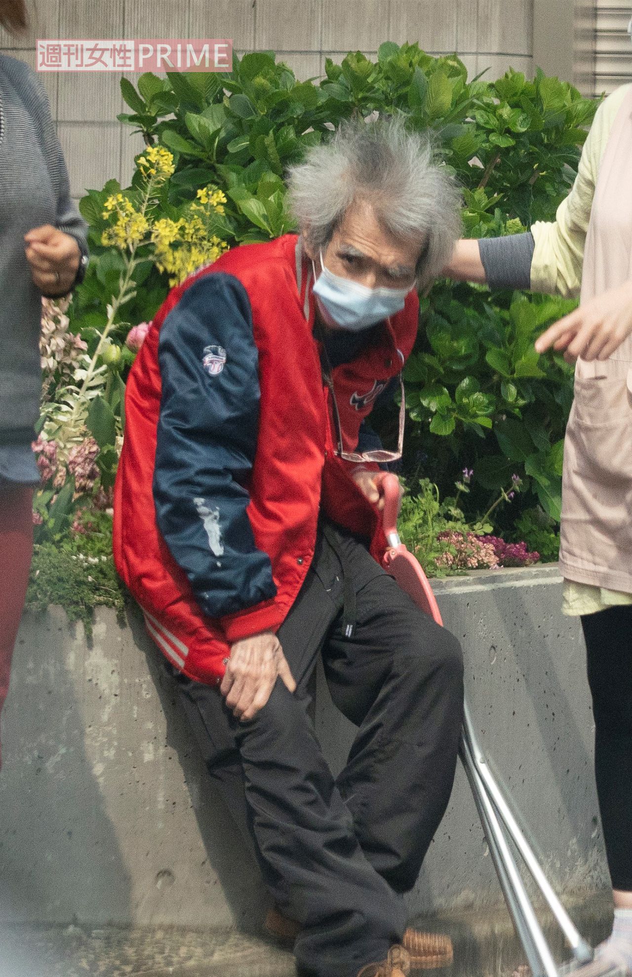 4月上旬、家政婦らしき女性に付き添われて自宅周辺を散歩する小澤