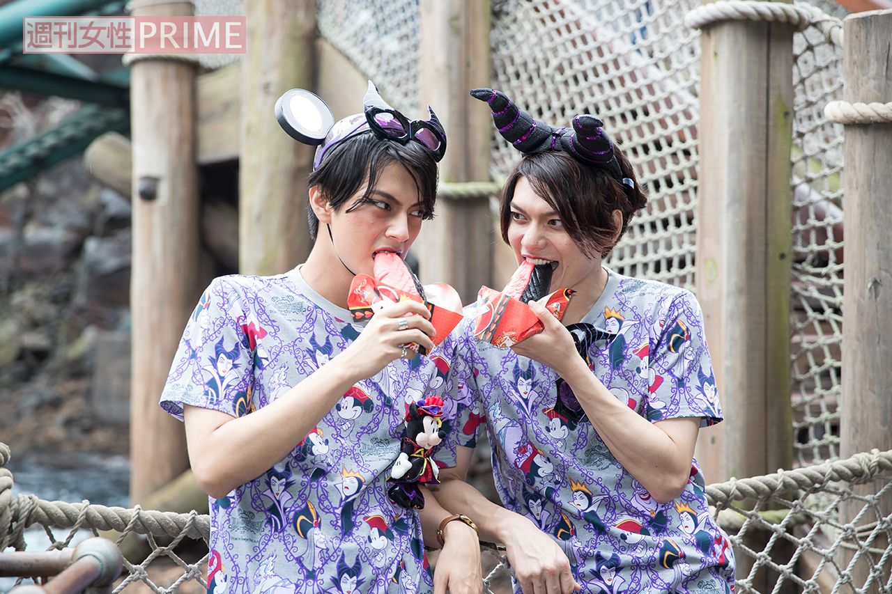 ギョウザドッグがハートの女王風のツートーンカラーに。ノーチラスギャレーにて1個550円。「この顔で食べてるところ撮って！」（中尾）、「SNS映えしそうな色だね」（崎山） 撮影／廣瀬靖士 (c)Disney