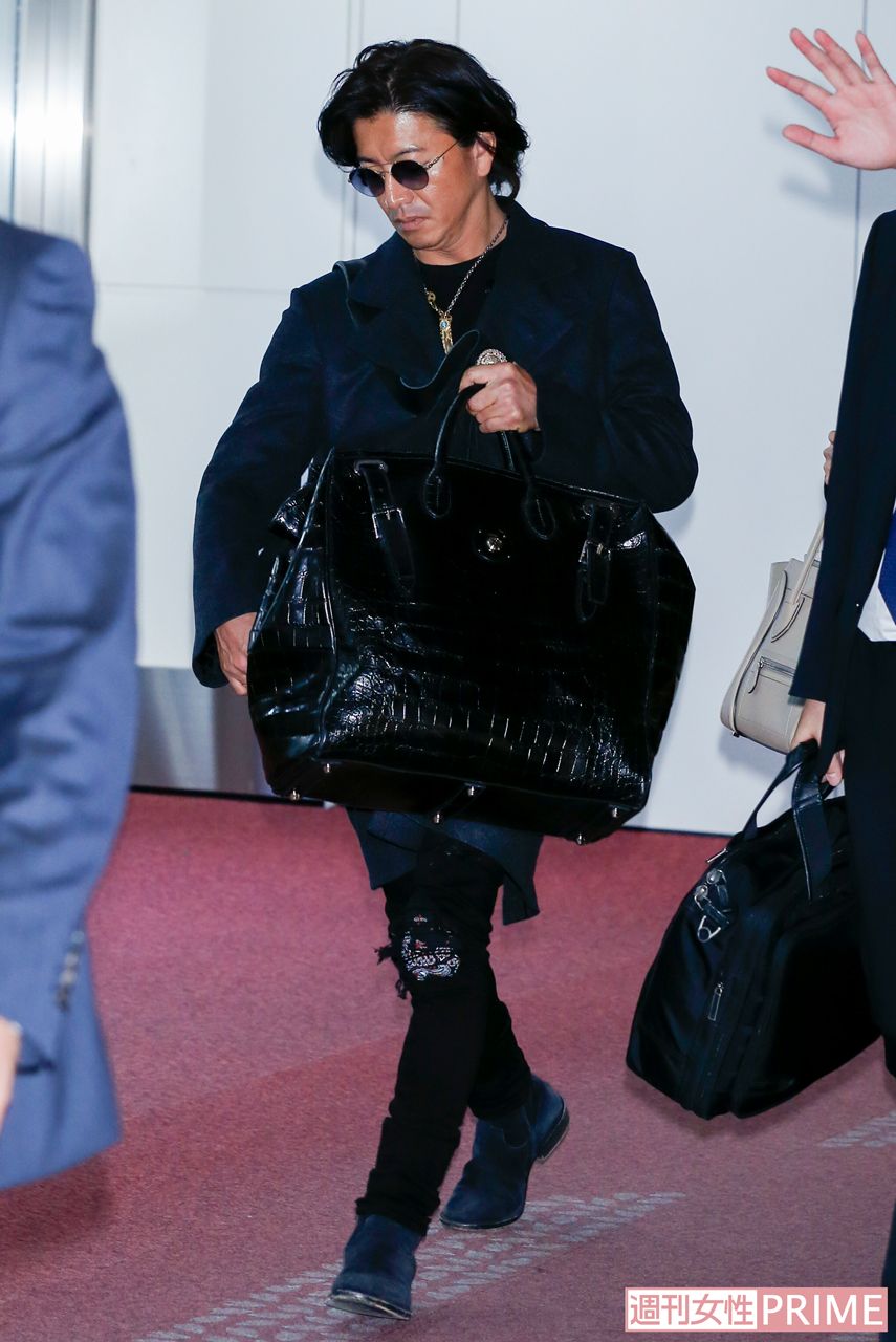 刺し子でペイズリー柄があしらわれたデニムや、ラルフローレンのセミオーダーのバッグと“ちょいワル”スタイルの木村拓哉（'18年）