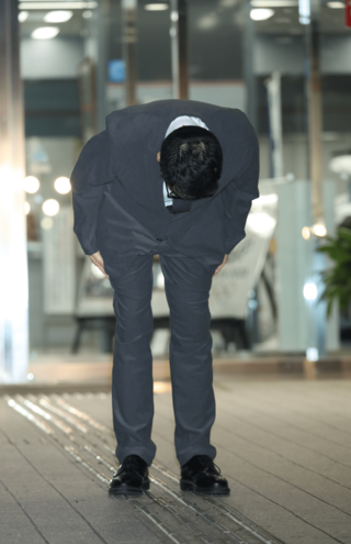 保釈され報道陣に向かって深々とお辞儀をする槇原敬之