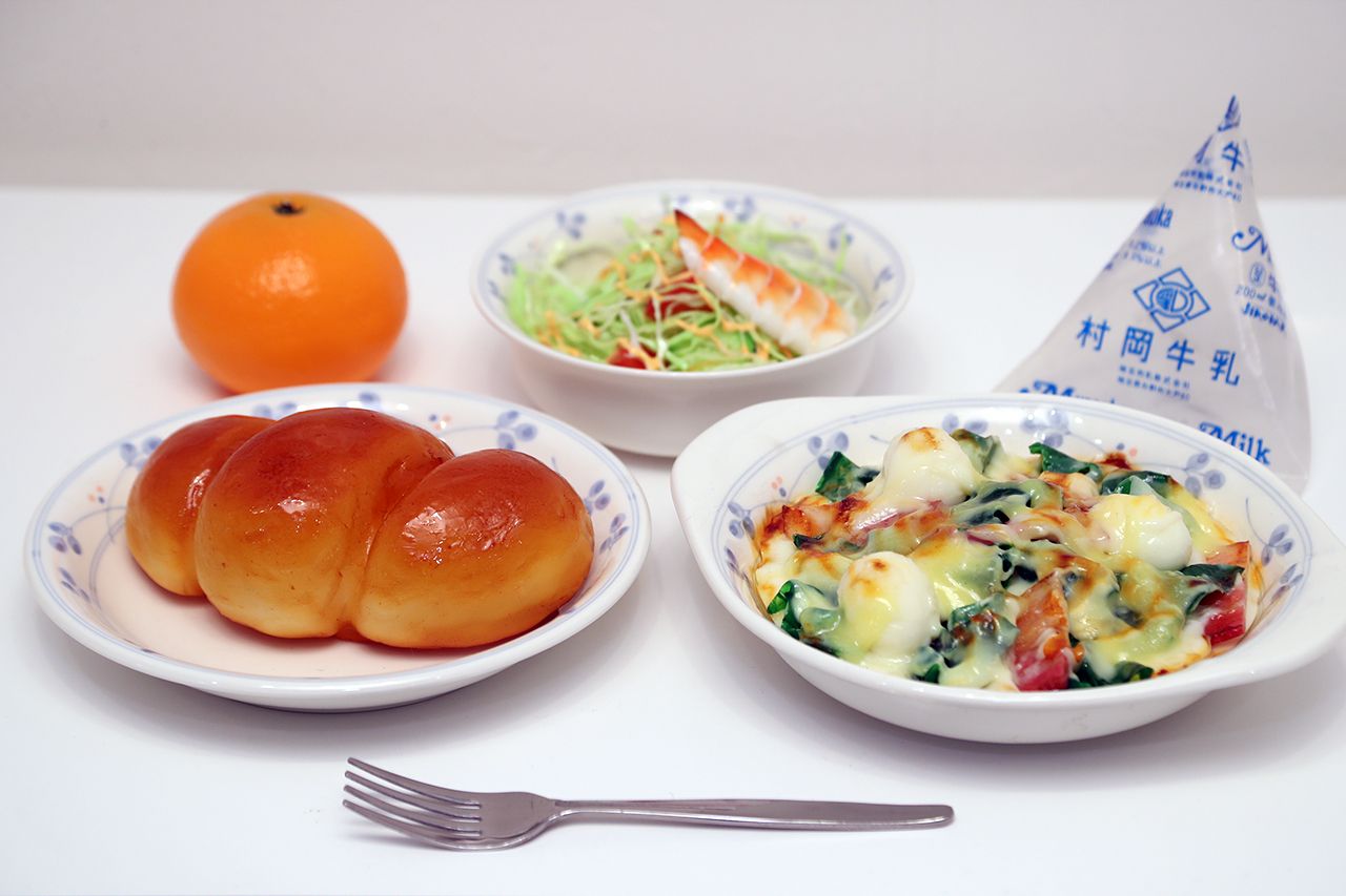 昭和58年（1983年）ツイストパン、ほうれん草と卵のグラタン、えびのサラダ、くだもの、牛乳