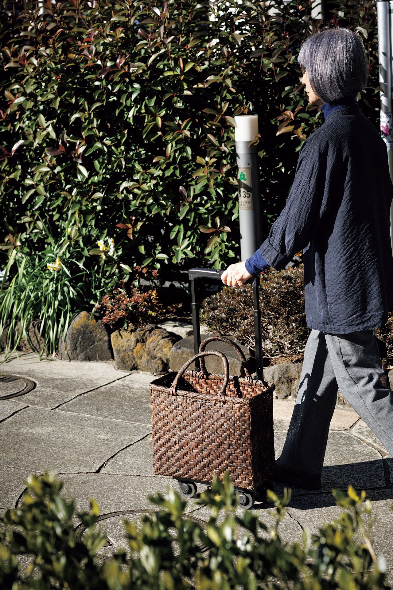 スーパーマーケットには、大切に使っていた山ぶどうのかごを取り付けたキャリーケースで　写真提供／長谷川 潤（書籍『85歳現役、暮らしの中心は台所』より）