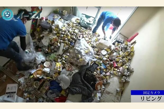 大量のビールの空き缶が散らばったリビングを片付ける様子（写真：「イーブイ片付けチャンネル」より）