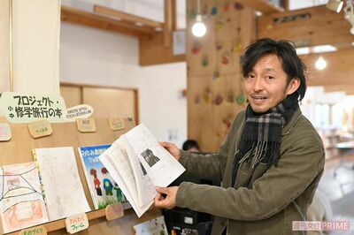 校内で販売している修学旅行の冊子を見せてくれた校長の加藤さん（撮影／渡邉智裕）