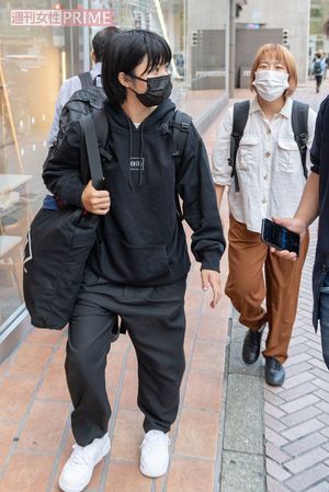 直撃に答える加納と、後ろでニヤニヤしながら加納の反応を伺う村上