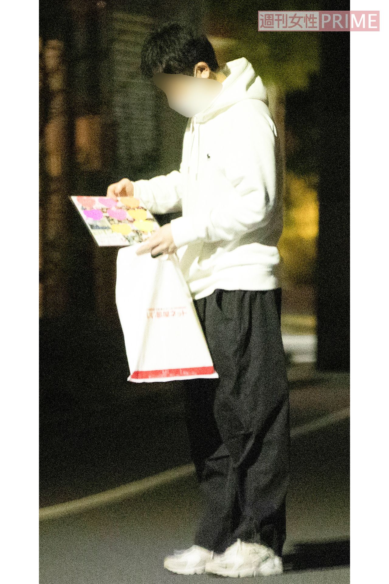 飲み会の会場前で色紙を眺める研修医と思われる男性