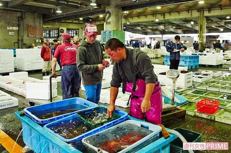 赤い競り帽をかぶり、小田原漁港を自由に歩き回る依田シェフ（右から2人目）。盟友でもあるヒラメ漁師の伊代田工さん（手前）と 撮影／寺澤太郎