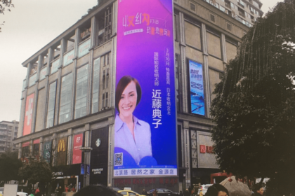 仕事で訪れた中国ではビルの前面に近藤さんの顔。実は本人の許可なし広告だという。