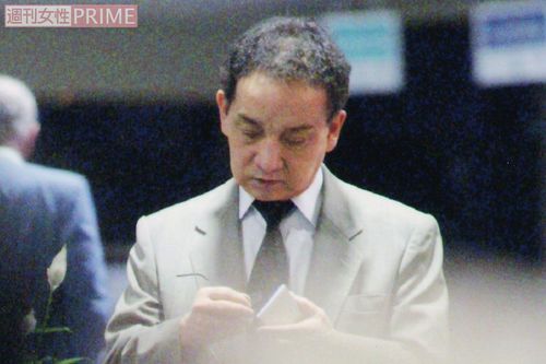 空港で手元を覗き込むジャニー喜多川社長