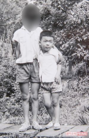 半世紀以上前、兄と肩を組む容疑者。どこにでもいる仲よしの兄弟に見えるが（兄提供）