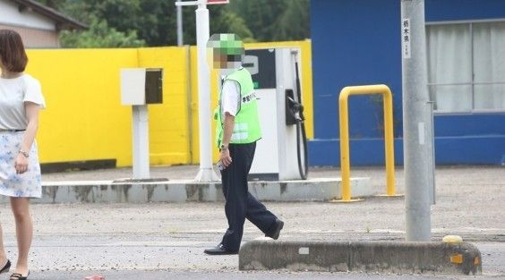 記者（写真左）をマークする監視員。記者の真後ろにピッタリつくことも